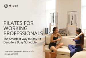 Two working professionals discussing their Pilates workout session in a modern Pilates studio in Guwahati.